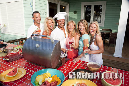 Happy group of friends enjoying BBQ stock photo