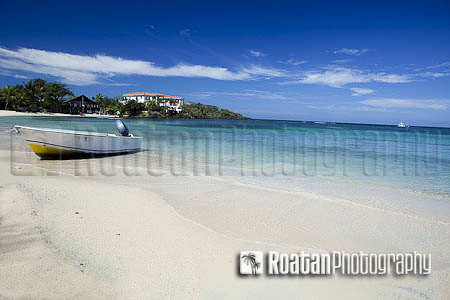 Small skiff beached on caribbean beach west end stock photo