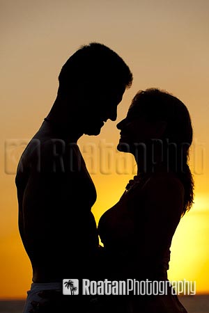 Couple embracing sunset silhouette stock photo