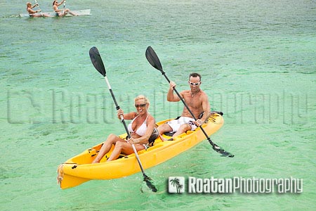 Couple kayaking in yellow kayak in Caribbean Sea stock photo