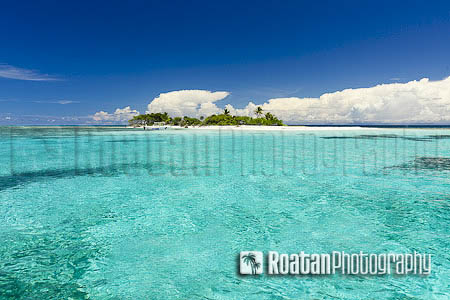 Tropical island surrounded by clear sea stock photo