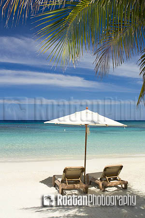 Two empty chairs on tropical beach looking out over Caribbean Sea stock photo